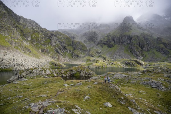 Two female mountaineers in a cloudy mountain landscape, Kreuzsee mountain lake, Wiener Höhenweg,