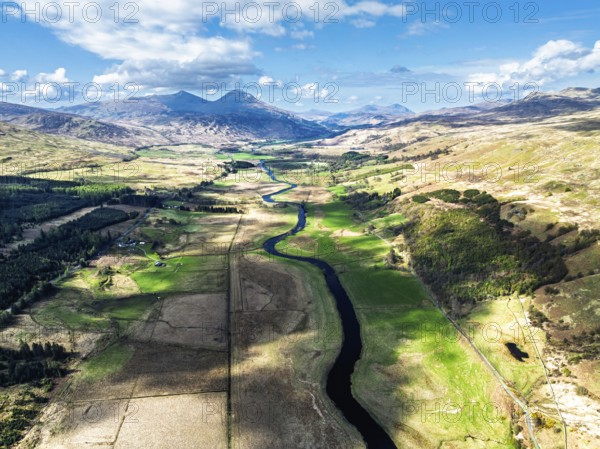 Farms and Mountains over River Dochart and Road A85 from a drone, Perthshire, Scotland, UK