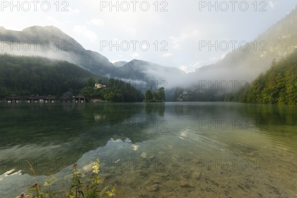 Mystical morning at Königssee in Schönau with boathouses and Christlieger. Sunrise and beautiful