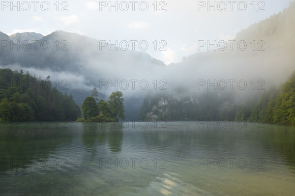 Mystical morning at Königssee in Schönau with boathouses and Christlieger. Sunrise and beautiful