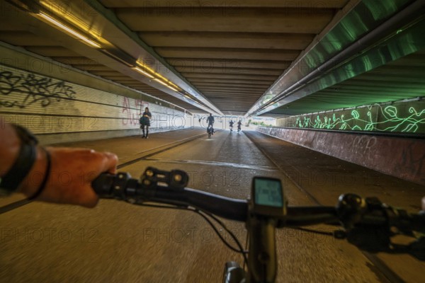 Ride your bike through the tunnel under the tracks of Utrecht Central, HBF, on the central cycle