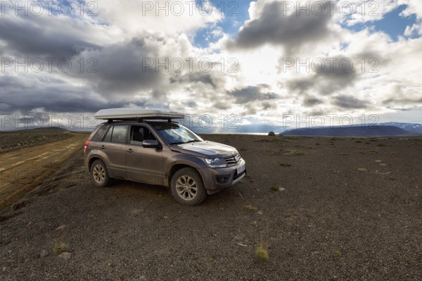 SUV, SUV with roof tent parked next to gravel road F35, Kjalvegur Kjölur, barren stony volcanic
