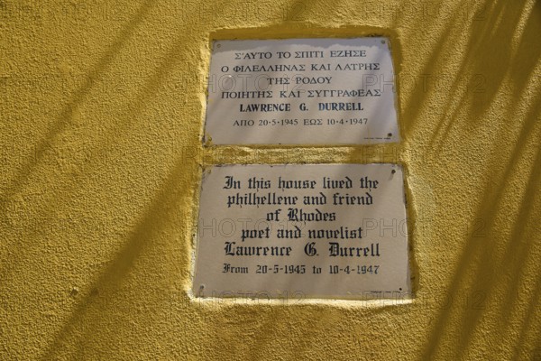 House of Lawrence Durrell, memorial plaques on a yellow wall with quotes by Lawrence G. Durrell,