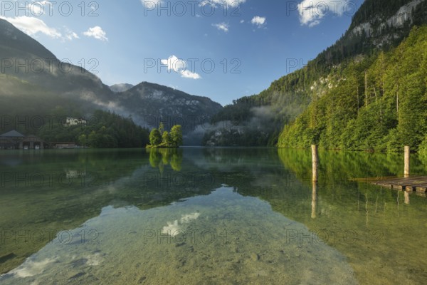 Mystical morning at Königssee in Schönau with boathouses and Christlieger. Sunrise and beautiful