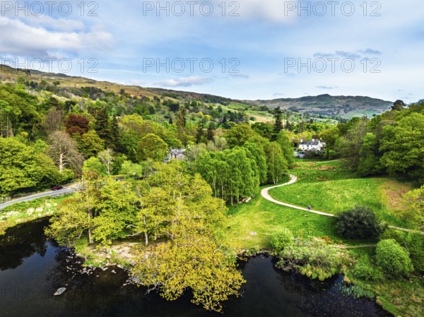 Farms and Mountains over road A591 from a drone, Grasmere Lake, Grasmere, Ambleside, Lake District,