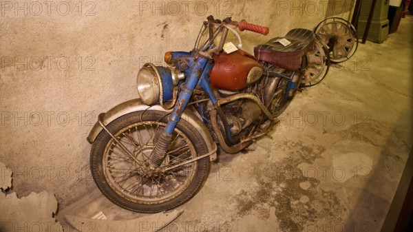 An old, dusty motorbike on display in a bunker, War Museum, Military Museum, Tunnel Museum, Lakki,