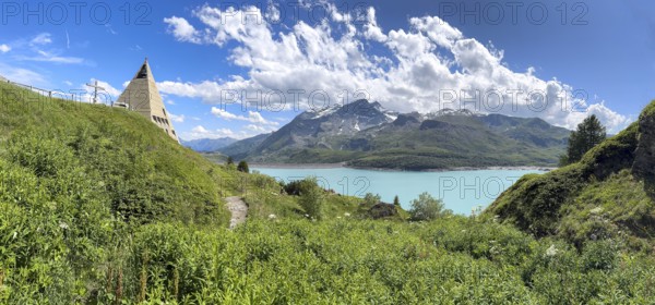 Panoramic view from plateau above Lanslebourg-Mont-Cenis to reservoir Lac du Mont Cenis left Museum