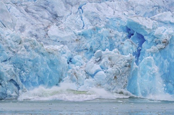 Collapsing ice wall of Fjortende Julibreen, 14th of July Glacier calving into Krossfjorden, Haakon