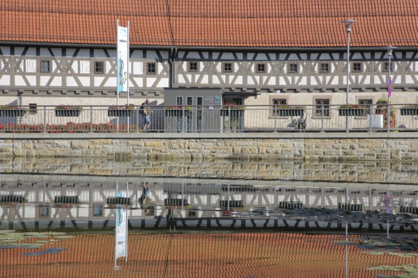 Armoury museum built in 1668 with reflection, half-timbered house, pond, bank, Suhl, Franconia,