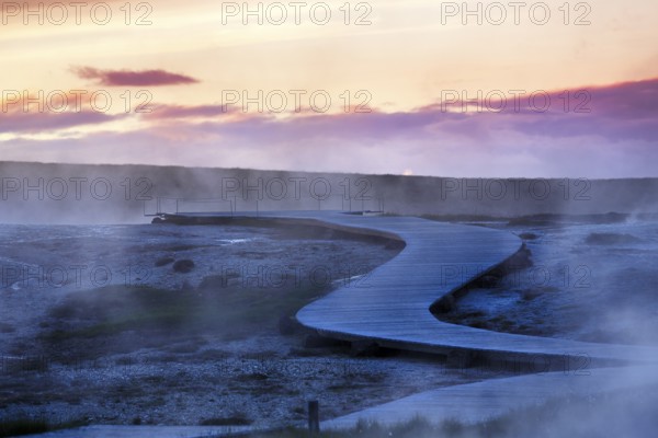 Curved wooden path, sulphur vapour, Hveravellir geothermal area, evening sky, Icelandic highlands,