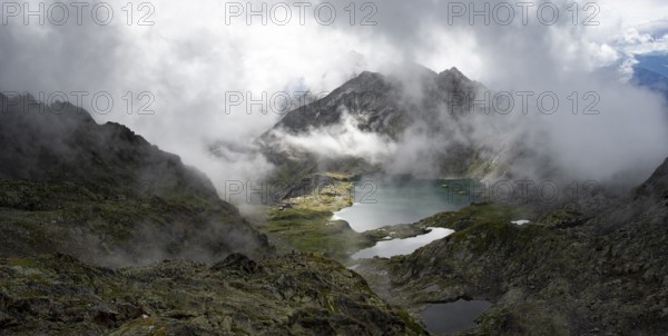View of mountain landscape with mountain lakes Wangenitzsee and Kreuzsee, cloudy mountain peaks,