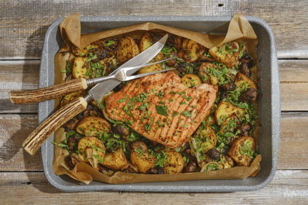 Juicy roasted turkey breast is beautifully presented on a tray with golden, seasoned potatoes and