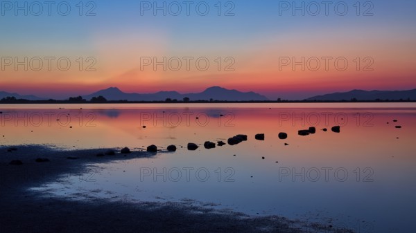 Varied colours during sunset over a calm lake, salt lake, Tigaki, nature reserve, hydro biotope,
