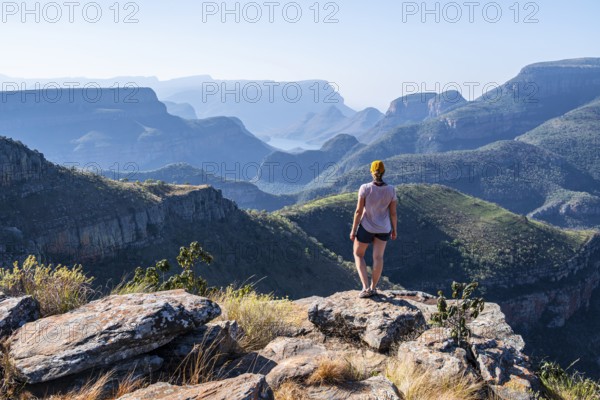 Tourist looking over canyon landscape, view of Blyde River gorge, Lowveld Viewpoint, in the evening