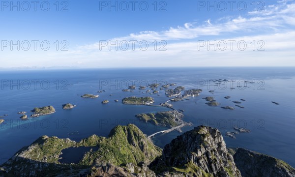 View of the sea and archipelago islands with the village of Henningsvær, Festvagstinden peak,