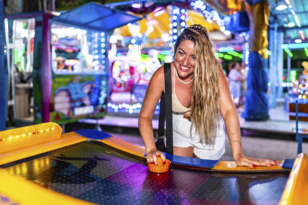 Happy tourist enjoying an exciting air hockey game in a vibrant luna park, experiencing fun and