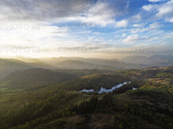 Sunset over Mountains and Coniston Water from drone, Lake District National Park, Cumbria, England,
