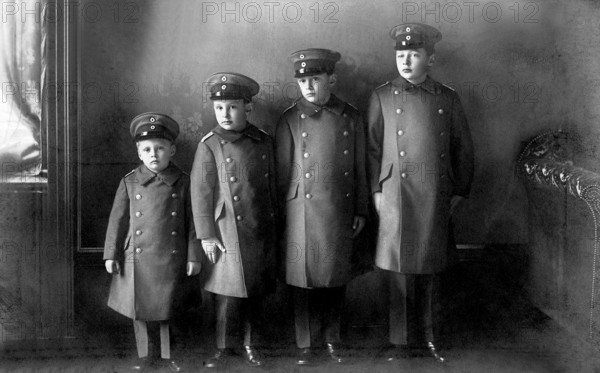 Four uniformed boys lined up in height, military, militarism, 1910s, group of boys in uniforms and
