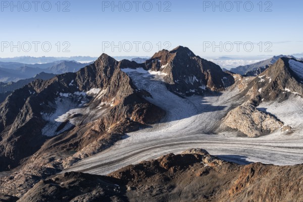 Picturesque high mountain landscape at sunrise, glacier and rocky mountain peaks in the morning