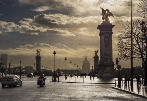 Clouds gather above the iconic Alexandre III Bridge as vehicles and people navigate the bustling