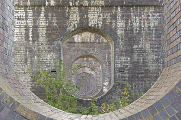 View through openings in piers of a railway viaduct, Stanway, Broadway, The Cotswolds, England,