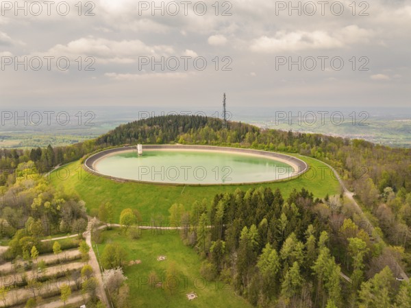 Upper reservoir Reservoir on a wooded hill with observation tower and green meadows, Glems