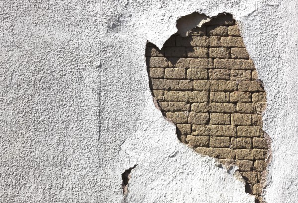 Building damage, wall damage, flaking plaster and wall paint, bricks