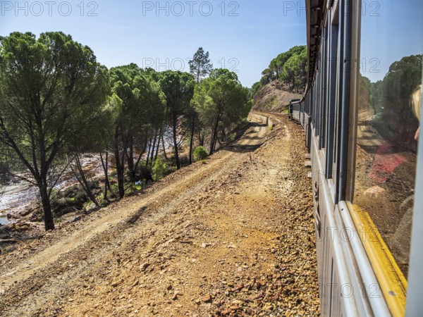 Views the train, touristic railroad line, Rio Tinto mining area, destroyed nature and remains of