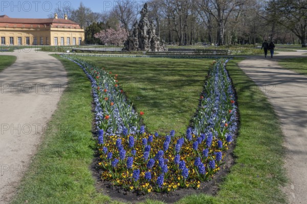 Planted spring beds in the palace park, behind the Huguenot fountain from 1706, Erlangen, Middle