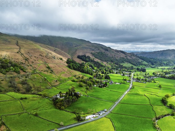 Farms and Mountains over road A591 from a drone, Grasmere Lake, Grasmere, Ambleside, Lake District,