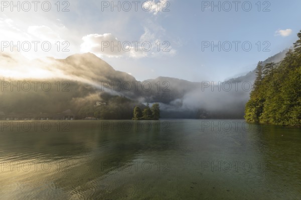 Mystical morning at Königssee in Schönau with boathouses and Christlieger. Sunrise and beautiful