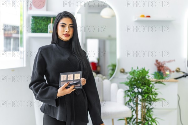 Professional makeup artist holding a palette and brush, offering makeup services in a modern and