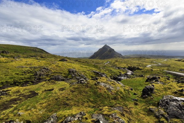 Barren moss-covered volcanic landscape, cone-shaped mountain Stapafell, rain clouds, changeable