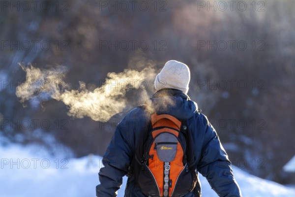 Person walking in very cold weather, Visual effect of the steam seen when exhaling in cold weather.