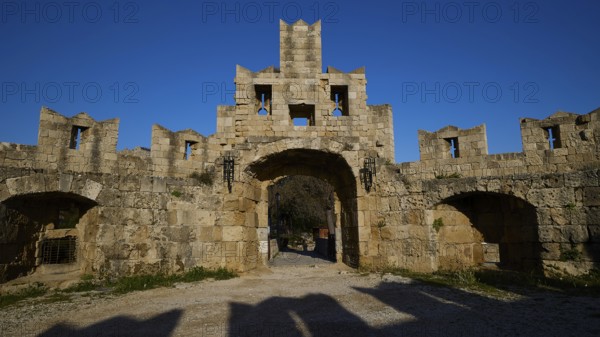 St Paul's Gate, Medieval stone castle gate under a clear blue sky, harbour area, Rhodes Town,
