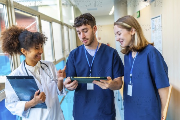 Doctors and nurses reviewing medical records on a tablet, collaborating on patient care in a