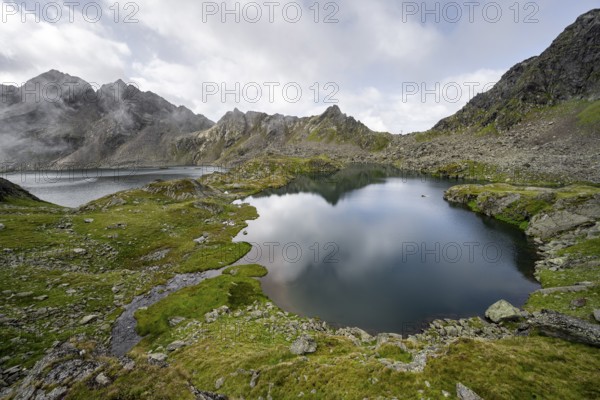 Mountain lakes Wangenitzsee and Kreuzsee, cloudy mountain peaks in the morning, Schober group, Hohe