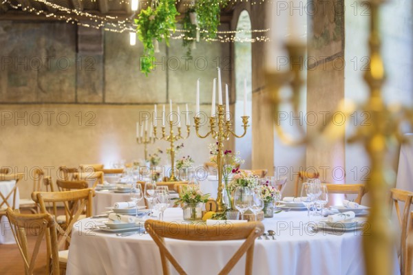 Elegant and romantic wedding tables with candles and natural decoration, event and wedding location
