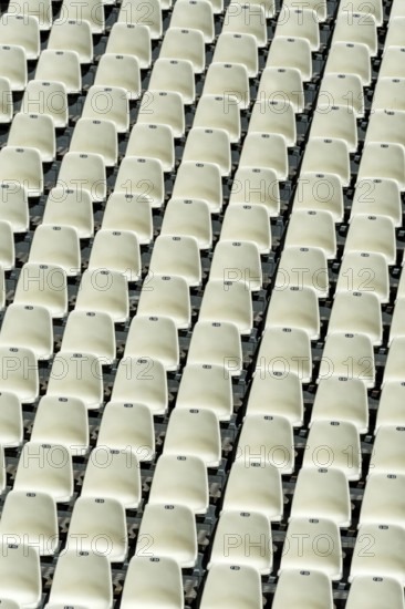Empty stadium seats arranged in neat rows highlight the readiness for an upcoming sports event or