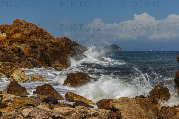 Rugged rocks and foaming spray on Topinetti beach, near Rio Marina, Elba Island, Tuscan Archipelago