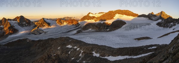 Picturesque high mountain landscape at sunrise with alpenglow, blue glacial lakes, glaciers and