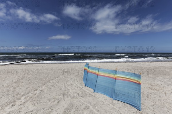 Deserted Baltic Sea beach with a single windbreak, blue sky, Kühlungsborn, Baltic Sea,