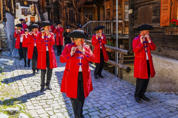 Pipers and drummers accompany the Corpus Christi procession, historic town centre, Grimentz, Val