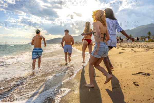 Friends running along the beach, soaking up the sun and enjoying a carefree summer vacation filled