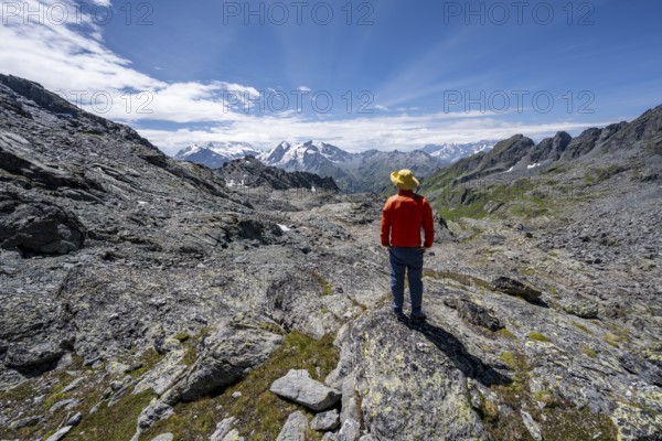 Mountaineer in rocky mountain landscape at the Col du Louvie, view of the summit of the Grand