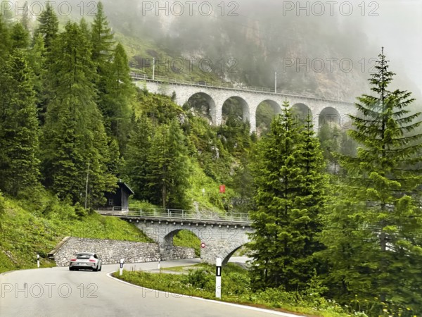 View of front Albula road Veja Alvra from Albula Pass towards Bergün with viaduct for railway in