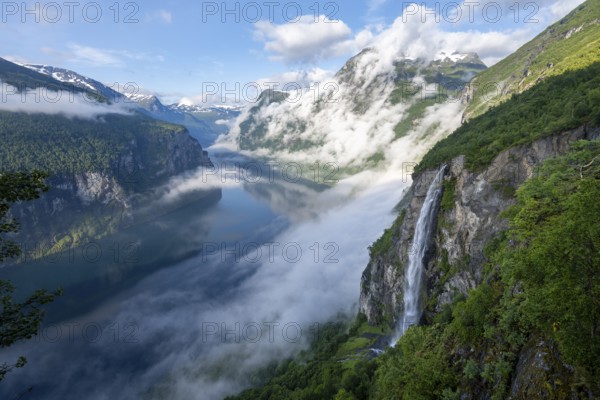 Gjerdefossen waterfall, at Ørnesvingen viewpoint, atmospheric clouds over the fjord in the morning