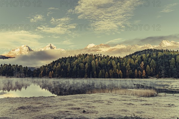 Lake Staz near Sankt Moritz in the Engadin in Switzerland. Morning atmosphere with fog in autumn.