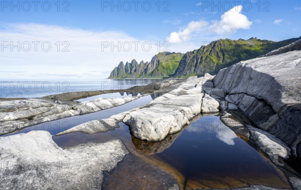 Reflection in a tidal pool, rocky coast of Tungeneset, Devil's Teeth, Okshornan, Ersfjorden, Senja