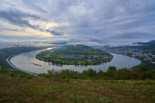 River bend at dusk with passing cargo ship and soft clouds in the sky, summer, Rhine bend Boppard,